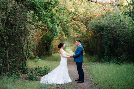 A couple in love a guy and a girl on a walk in the forest beltの写真素材