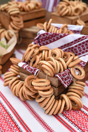 dry bagels and bagels on a table with a painted Ukrainian tableclothの写真素材