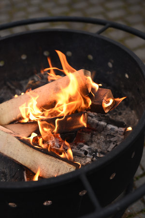 bright flame of a campfire in the barbecue grillの写真素材