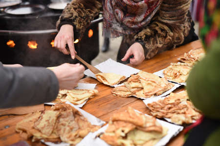 street cooking of pancakes on a large circular grillの写真素材
