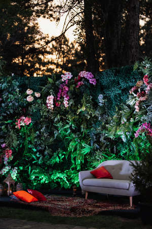 decorative bright green photo zone in marakan style with natural flowersの写真素材