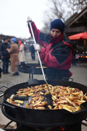 fried potatoes in a huge wok over high heatのeditorial素材