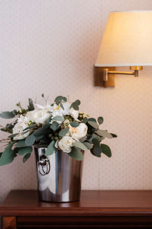 elegant wedding bouquet of fresh flowers and greenery in a bucketの写真素材