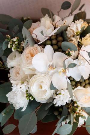 elegant wedding bouquet of fresh flowers and greenery in a bucketの写真素材