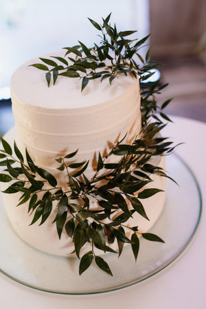 white wedding cake at the wedding of the newlywedsの写真素材