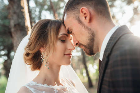 walk of the bride and groom through the autumn forest in Octoberの写真素材