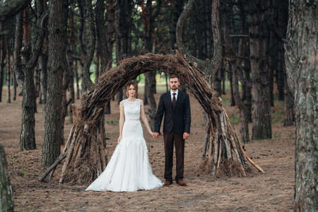 walk of the bride and groom through the autumn forest in Octoberの写真素材