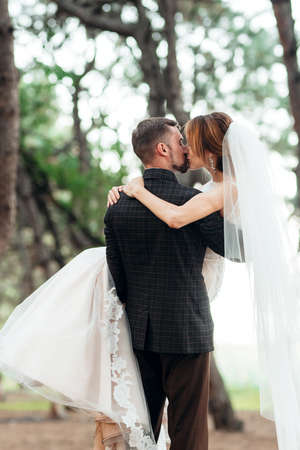 walk of the bride and groom through the autumn forest in Octoberの写真素材