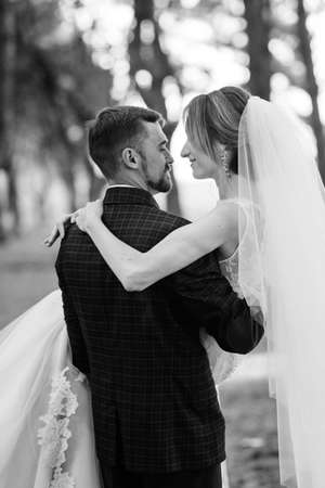 walk of the bride and groom through the autumn forest in Octoberの写真素材