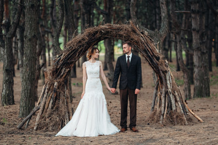 walk of the bride and groom through the autumn forest in Octoberの写真素材