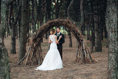 walk of the bride and groom through the autumn forest in Octoberの写真素材