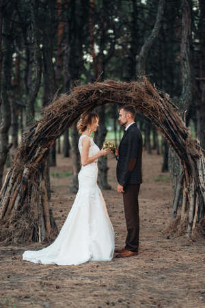 walk of the bride and groom through the autumn forest in Octoberの写真素材