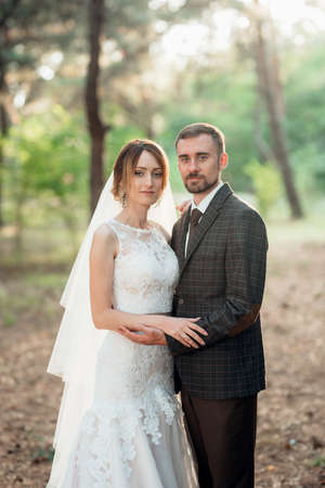 walk of the bride and groom through the autumn forest in Octoberの写真素材