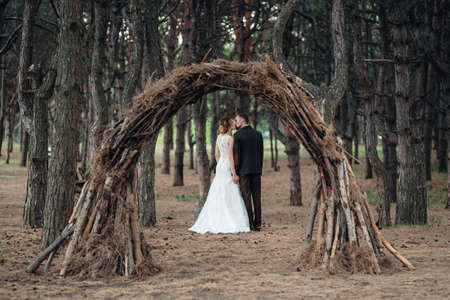 walk of the bride and groom through the autumn forest in Octoberの写真素材