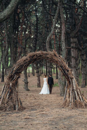 walk of the bride and groom through the autumn forest in Octoberの写真素材