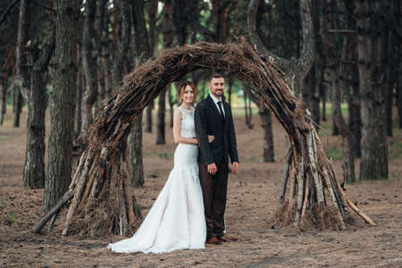 walk of the bride and groom through the autumn forest in Octoberの写真素材