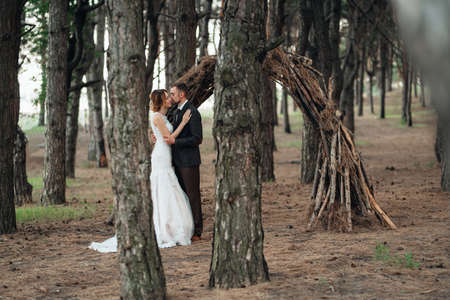 walk of the bride and groom through the autumn forest in Octoberの写真素材