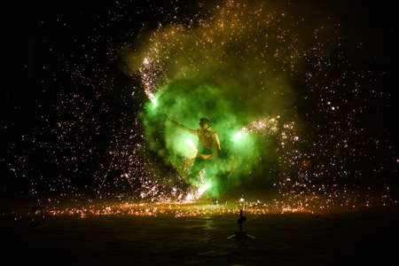 Night fiery pieces of a fire showの写真素材