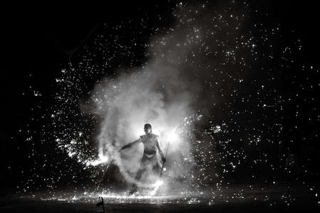 Night fiery pieces of a fire showの写真素材