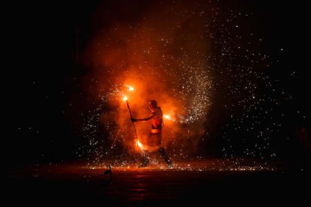 Night fiery pieces of a fire showの写真素材