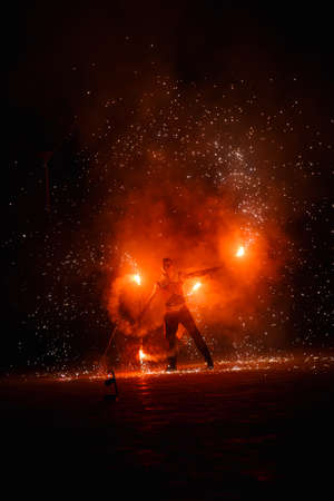 Night fiery pieces of a fire showの写真素材