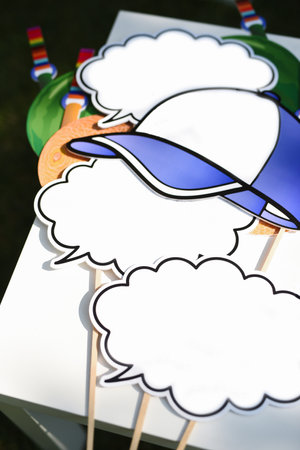 bright plates and attributes for inscriptions and photo sessions in the photo zone in the form of clouds and a baseball capの写真素材