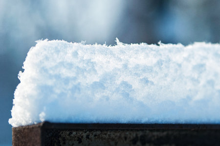 snow caps on the slabs of the village fenceの写真素材