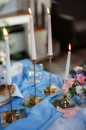 atmospheric candle decor with live fire on the banquet tableの写真素材