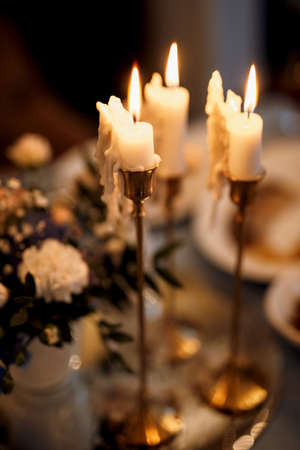atmospheric candle decor with live fire on the banquet tableの写真素材