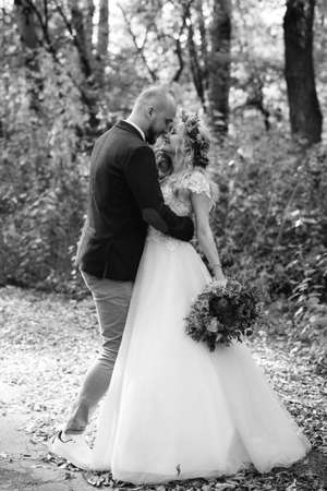 walk of the bride and groom through the autumn forest in Octoberの写真素材