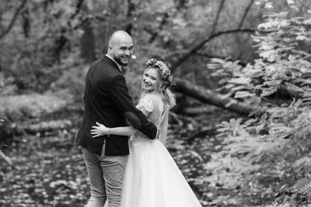 walk of the bride and groom through the autumn forest in Octoberの写真素材