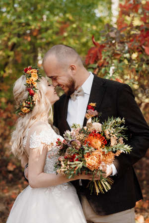 walk of the bride and groom through the autumn forest in Octoberの写真素材