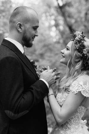 walk of the bride and groom through the autumn forest in Octoberの写真素材