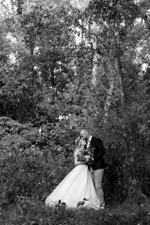 walk of the bride and groom through the autumn forest in Octoberの写真素材