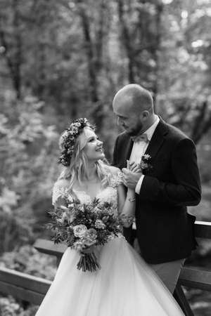 walk of the bride and groom through the autumn forest in Octoberの写真素材