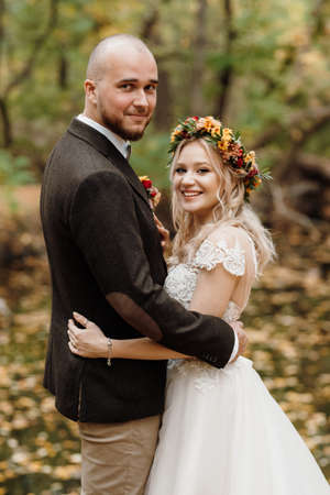 walk of the bride and groom through the autumn forest in Octoberの写真素材