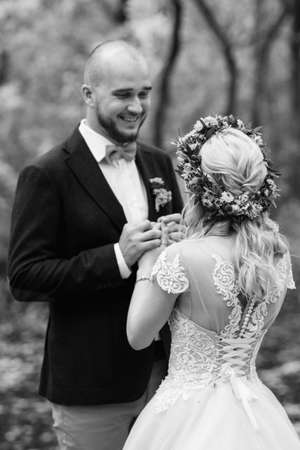 walk of the bride and groom through the autumn forest in Octoberの写真素材
