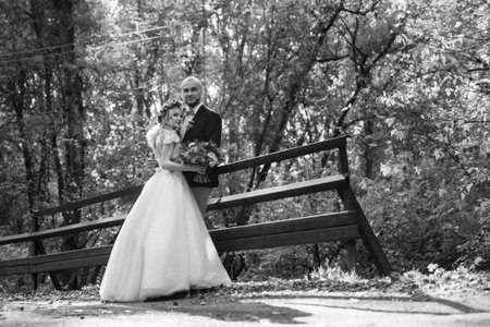 walk of the bride and groom through the autumn forest in Octoberの写真素材