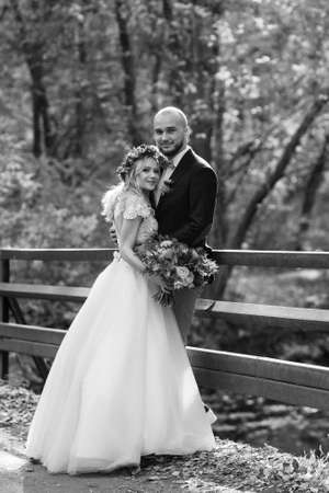 walk of the bride and groom through the autumn forest in Octoberの写真素材