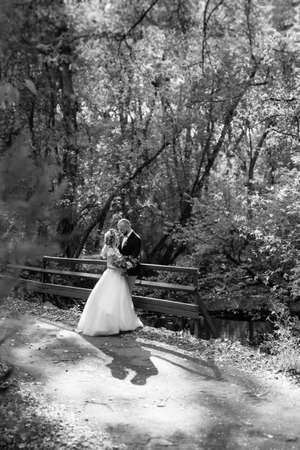 walk of the bride and groom through the autumn forest in Octoberの写真素材