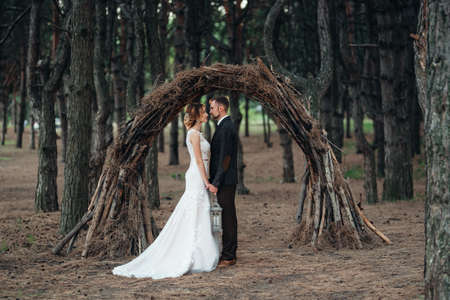 walk of the bride and groom through the autumn forest in Octoberの写真素材