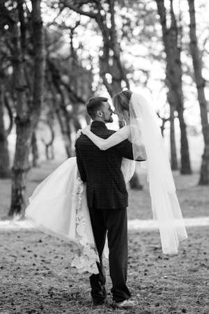 walk of the bride and groom through the autumn forest in Octoberの写真素材