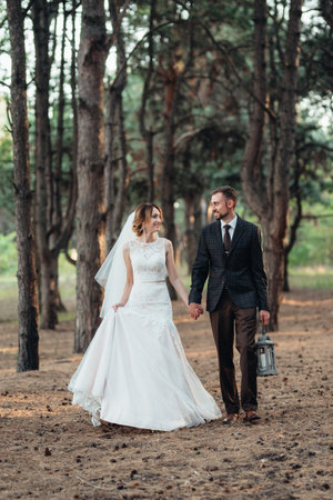walk of the bride and groom through the autumn forest in Octoberの写真素材