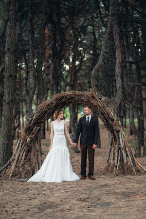 walk of the bride and groom through the autumn forest in Octoberの写真素材