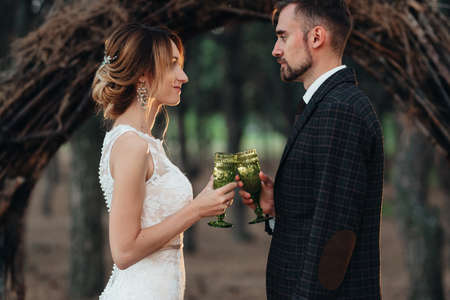 walk of the bride and groom through the autumn forest in Octoberの写真素材
