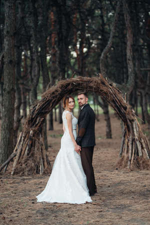 walk of the bride and groom through the autumn forest in Octoberの写真素材
