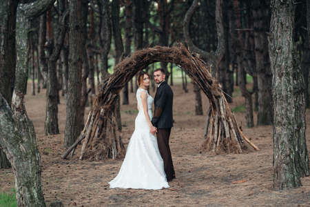 walk of the bride and groom through the autumn forest in Octoberの写真素材