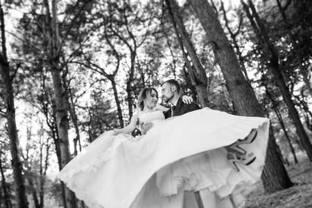 girl in a wedding dress in the autumn forest against the background of wild treesの写真素材
