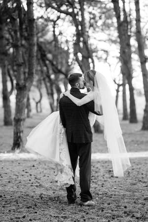 walk of the bride and groom through the autumn forest in Octoberの写真素材