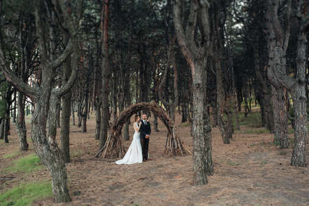 walk of the bride and groom through the autumn forest in Octoberの写真素材